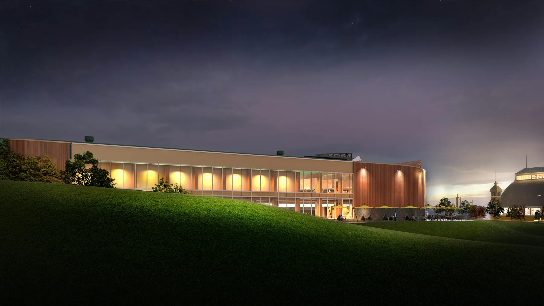 Official view of the Event Centre glazed facade, planted slope and surrounding landscape